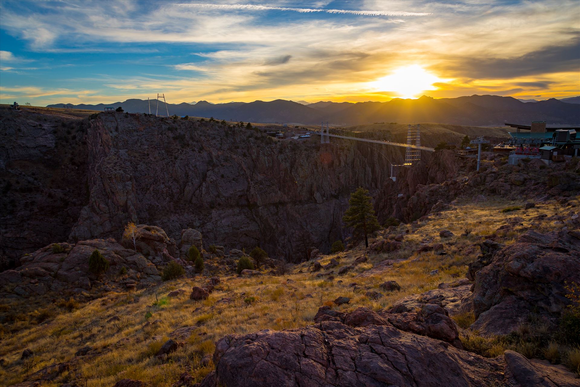 Royal Gorge No 3 - The sun sets over the bridge at the Royal Gorge, near Canon City, Colorado. The bridge is the highest bridge in North America, at almost 1,000 feet over the Arkansas River. by Scott Smith Photos