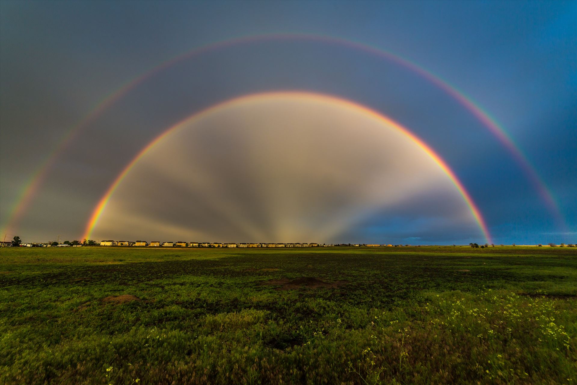 Double Rainbow with Anti-Crepuscular Rays - After a hard rain and a bit of hail, anti-crepuscular rays appear to cast from the center of a double rainbow, near Reunion, Colorado. by Scott Smith Photos