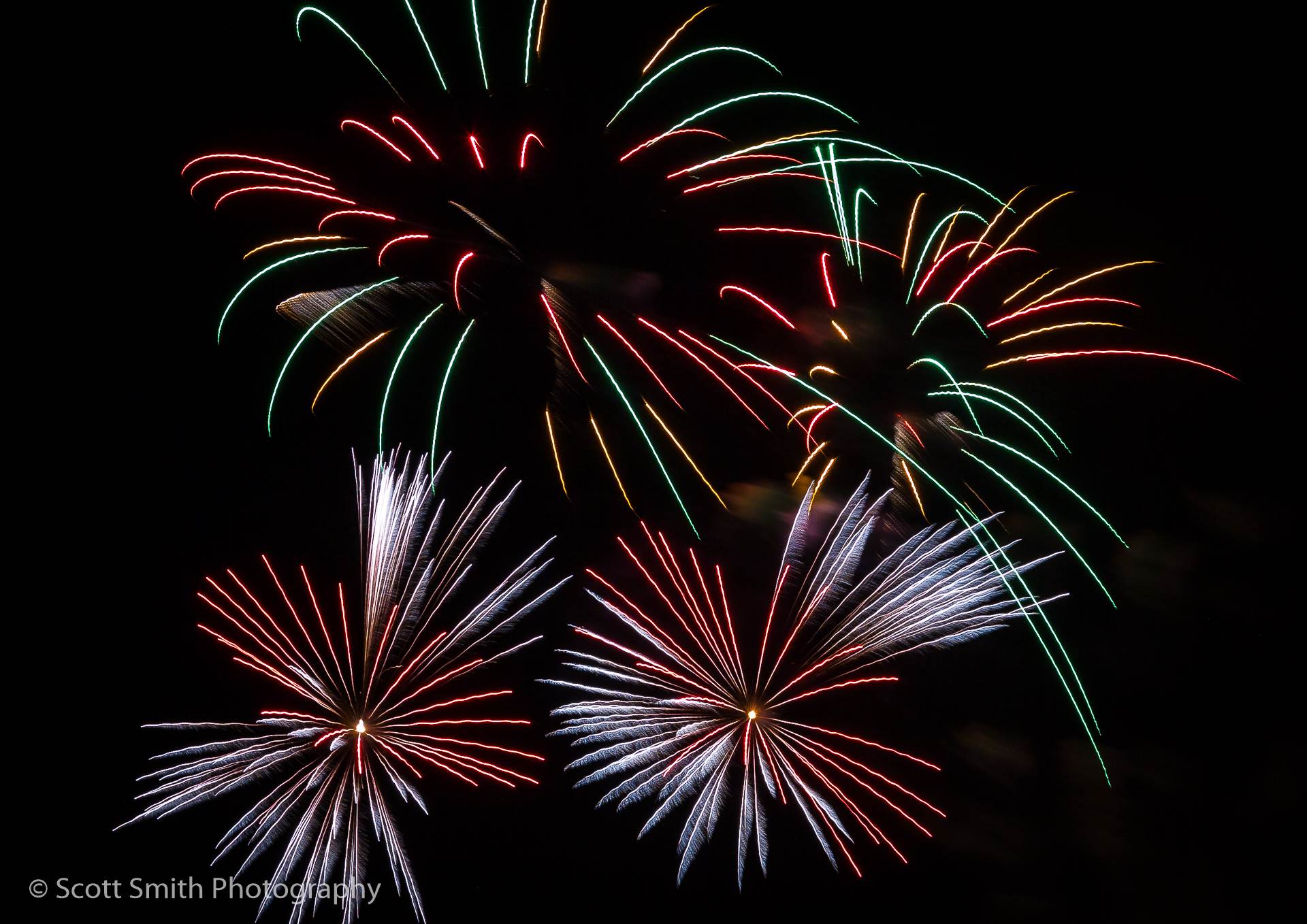 Fireworks in Denver - The long, sparse trails create interesting patterns in the sky. by Scott Smith Photos