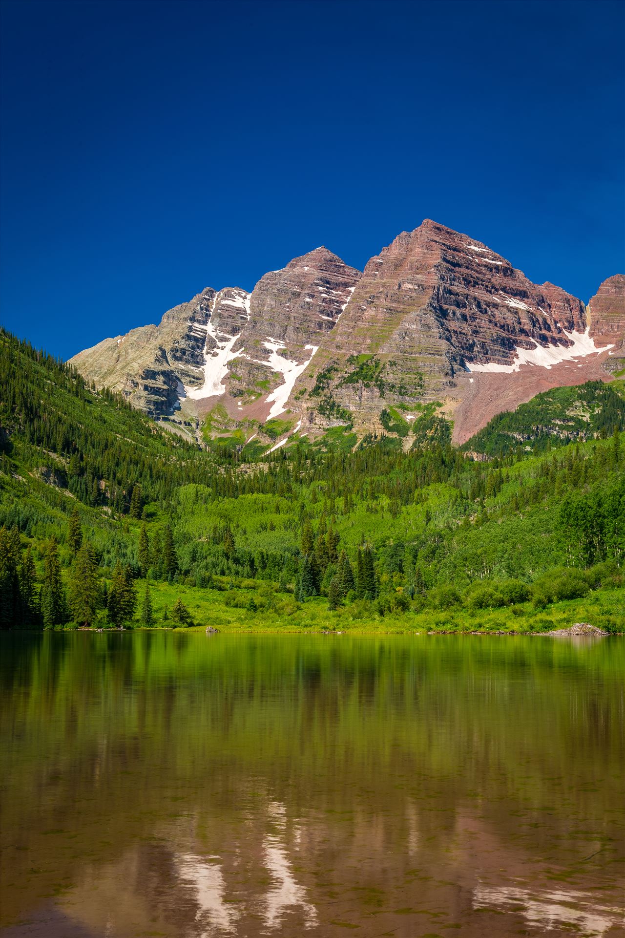 Maroon Bells in Summer No 07 - The remaining snow reflected in the water, at the Maroon Bells near Aspen, Colorado. by Scott Smith Photos