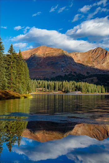 Lake Irwin reflects the Ruby Range mountains just after sunrise near Kebler Pass,  Colorado.