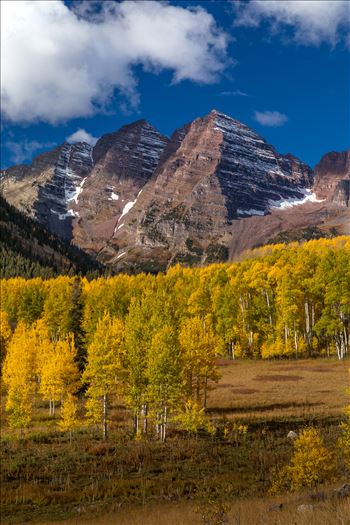 The Maroon Bells a few miles from the lake framed by beautiful fall aspens.