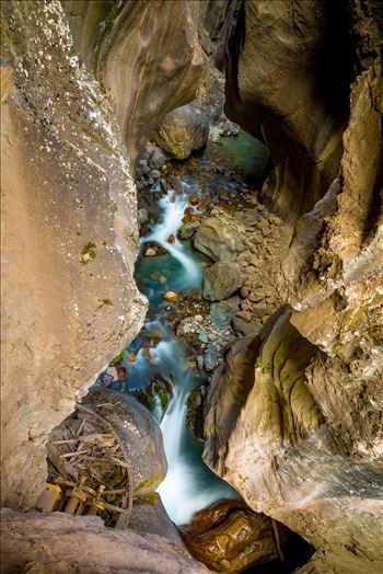 The stream leading to an amazing waterfall at the end of a narrow box Canyon in Ouray,Colorado. A difficult shot, both in terms of lighting and location, I leaned over the rail a good amount to avoid getting the walkway in the shot.