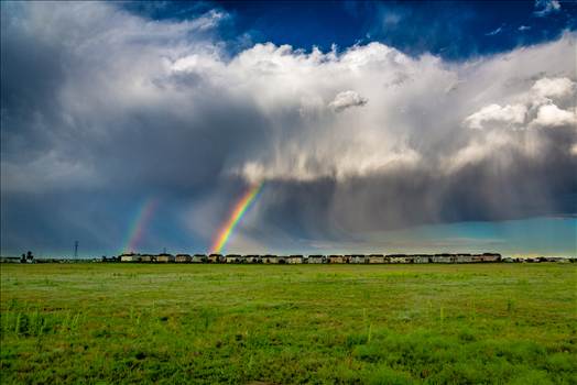 A double rainbow breaks through some clouds east of Denver.