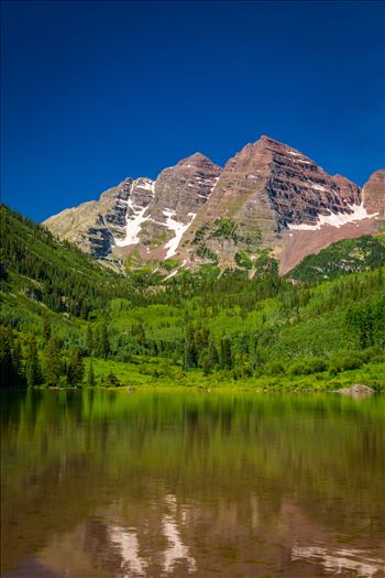 The remaining snow reflected in the water, at the Maroon Bells near Aspen, Colorado.
